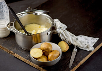 mashed potatoes in a saucepan. fresh organic mashed potatoes on a wooden table