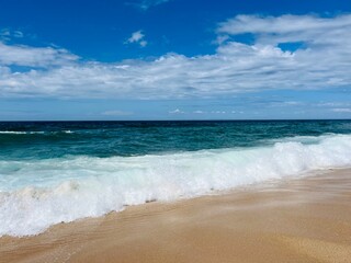Fototapeta na wymiar Empty sand beach, blue seashore
