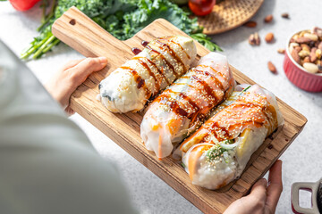 Group of spring rolls with rice paper filled with vegetables.
