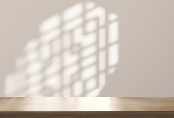 Blank brown wooden counter table in sunlight, Chinese round window grill shadow on beige fabric...