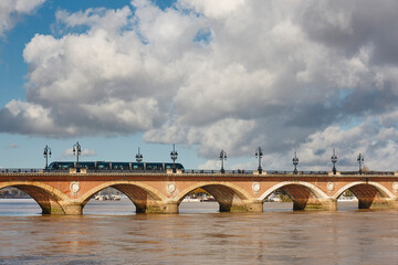 Fototapeta premium Garonne river and Pont de Pierre bridge. Transport. Bordeaux, France
