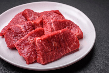 Fresh juicy raw beef slices with salt and spices