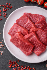 Fresh juicy raw beef slices with salt and spices