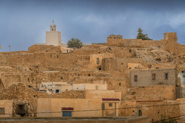 The old city (Medina), stone houses and the mosque minaret in the Tunisian town of Tamezre, southern Tunisia.