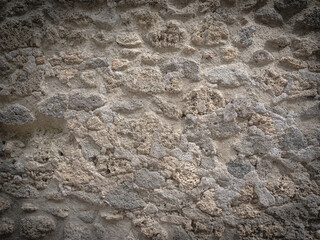 An old wall made of bricks that have been eroded by time.