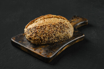 Whole loaf of artisan bread with sunflower seeds - obrazy, fototapety, plakaty