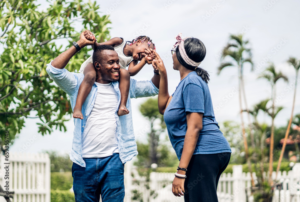 Wall mural Portrait of enjoy happy love black family. play, having fun, daughter, parenthood, care, african american father and mother with little african girl child smiling moments good time at home