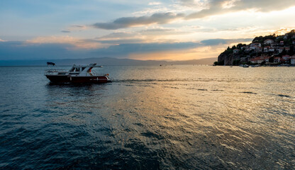 Beautiful sunset scene at Ohrid lake in Northern Macedonia. Boats floating at Ohrid lake in summer.