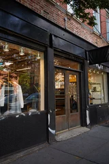 Zelfklevend Fotobehang clothing store with glass showcases on street in shopping district of new york city, urban scene © LIGHTFIELD STUDIOS