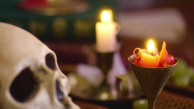 Dark and Mystical: Close-up of Candle, Skull, and Vintage Books - Gothic Aesthetics