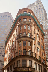 Fototapeta na wymiar vintage stone building against modern skyscrapers, architectural symbiosis in new york city