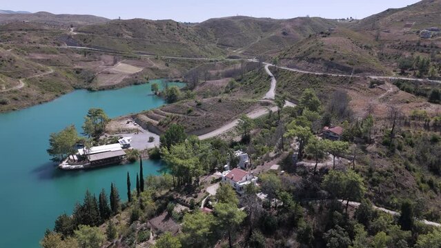 Aerial view orbiting waterfront properties along Green lake in the valley of the Taurus mountains in Turkey