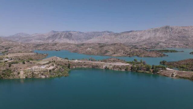 Flying across stunning turquoise waters of Green lake in the Taurus mountains of Turkey