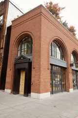 brick building with portico and arch window in downtown of new york city, urban architecture