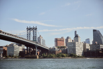 Fototapeta na wymiar Manhattan bridge over east river and picturesque new york cityscape with modern skyscrapers