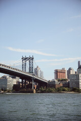 Fototapeta na wymiar Manhattan bridge over east river and scenic new york cityscape with modern skyscrapers, autumn scene