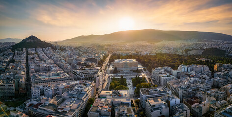 Panoramic aerial view of the City Center of Athens, Greece, with Syntagma Square and Parliament building during golden sunrise time