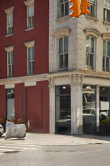 traffic light and corner of building on urban crossroad in downtown of new york city, streetscape