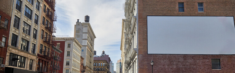 Fototapeta na wymiar vacant billboard with empty advertising space on building of downtown street in new york city