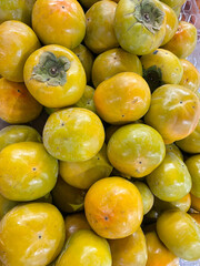Sweet persimmons in the market, close-up,
