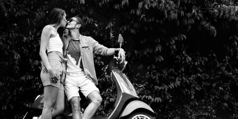 couple in love, a man and a girl on a bike. romantic ride on an Italian red scooter. girl hugging boyfriend - obrazy, fototapety, plakaty