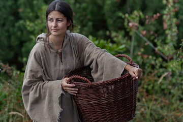 Young medieval peasant woman with basket