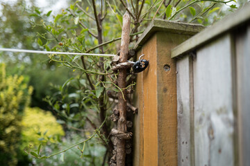 Shallow focus of a tethered washing line attached to a fence post by way on an in focus tie.