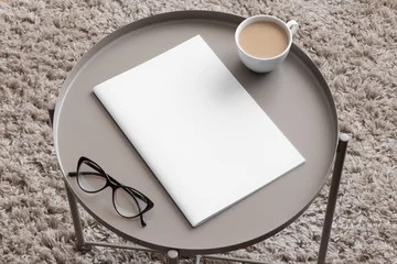 Magazine mockup with a cup of coffee on the beige table. © Snoflinga