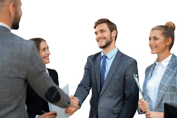 Business partners handshaking over business objects on workplace on a transparent background