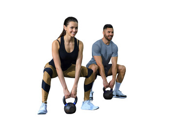 Fit and muscular couple focused on lifting a dumbbell during an exercise class on a transparent...