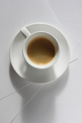 Fresh Strong Espresso Shot Served on White Desk with Sheets of Paper. Coffee Break Refreshment.