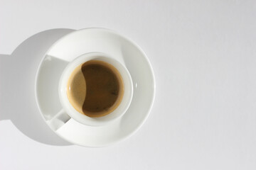 Freshly Brewed Espresso in White Ceramic Cup on White Background with Right Copy Space.