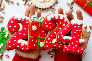 Obraz premium Banner for Christmas and New Year gingerbread cookies numbers 2024 on white background in child hands