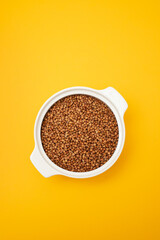 Raw toasted buckwheat in a white ceramic bowl