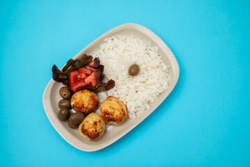 Chicken meatballs with salad and boiled rice