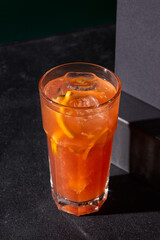 A vibrant raspberry-grapefruit lemonade served chilled, offering a burst of tangy sweetness against a sleek black backdrop