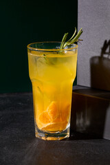 Mandarin lemonade elegantly served in a highball glass, set against a contrasting black backdrop, capturing the essence of refreshing zestiness