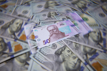 50 hryvnyas banknote isolated on US 100 dollar banknotes