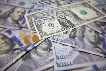 US 1 dollar banknote isolated on US 100 dollar banknotes