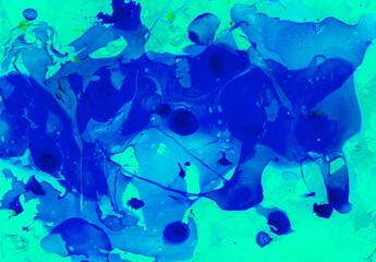 Abstract background from chaotic spots of different shades of blue. Marble effects, blur. Ink or paint in water. Different forms. Green drops. Turquoise background.