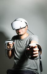 Young man using VR headset. Guy playing with VR glasses