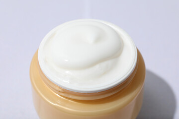 Jar with cream on white background, close up