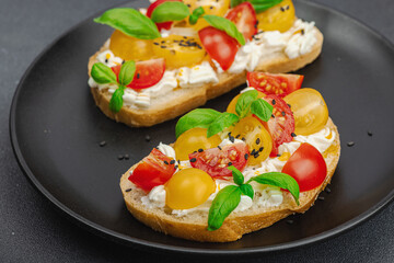 Fresh bread sandwiches with tomato cherry, cream cheese and basil leaves. Morning breakfast concept