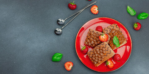 Obraz na płótnie Canvas Delicious chocolate cakes with fresh strawberries. Sweet dessert, good morning concept