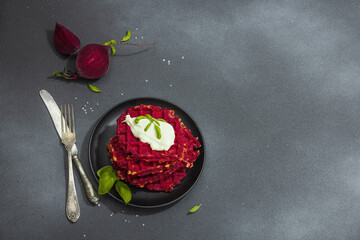 Homemade beetroot Belgian waffles with sauce. Gluten free vegan food with vegetables