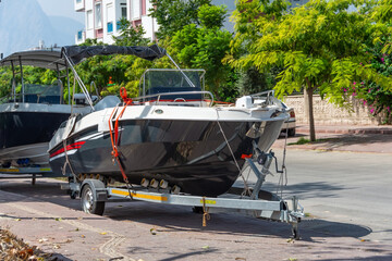 High-speed fishing boat is tied and loaded onto a trailer for transportation over land and roads...