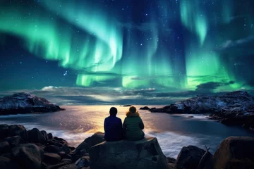 Poster Im Rahmen A couple watching aurora borealis northern lights in winter © blvdone