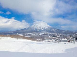 Fototapeta na wymiar Ski slope with the view of snowy volcano (Niseko, Hokkaido, Japan)