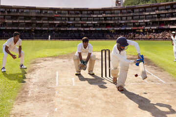 Batsman hitting the ball on the leg side while playing a cricket match