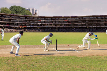 Batsman missing the ball while trying to defend it, while playing a cricket match